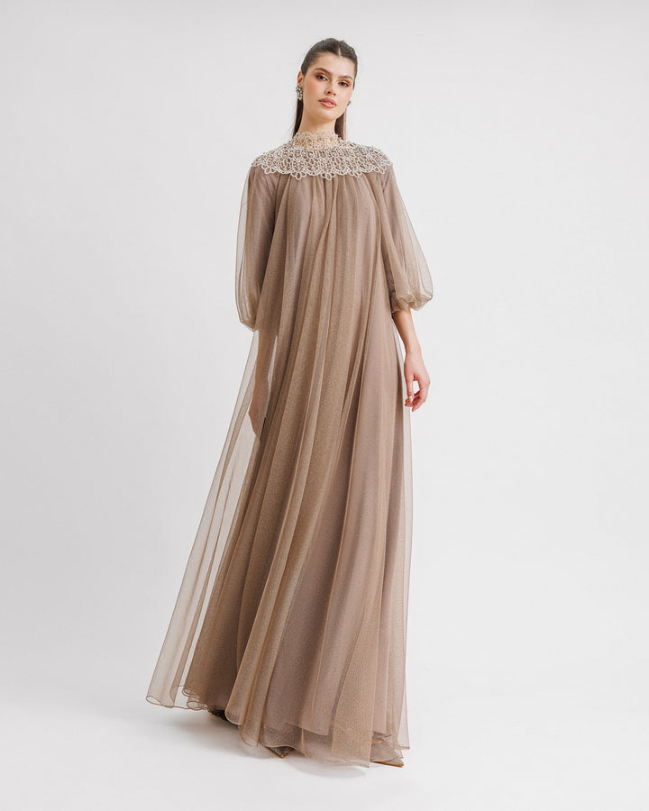 A taupe color kaftan-style loose-cut tulle dress with lace at the neckline and three-quarter sleeves.