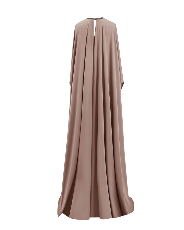 The back of a kaftan-style evening dress in taupe color with a beaded neckline and three-quarters sleeves.