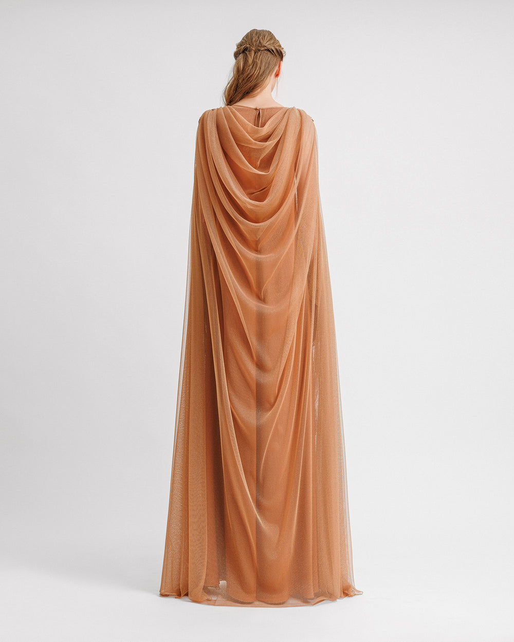 A loose-cut kaftan style copper evening dress with a draped back.