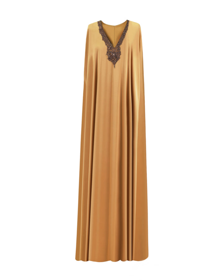 A caramel color kaftan-style evening dress with a beaded V-neckline.