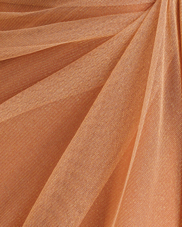 A close-up of a shiny copper tulle fabric.