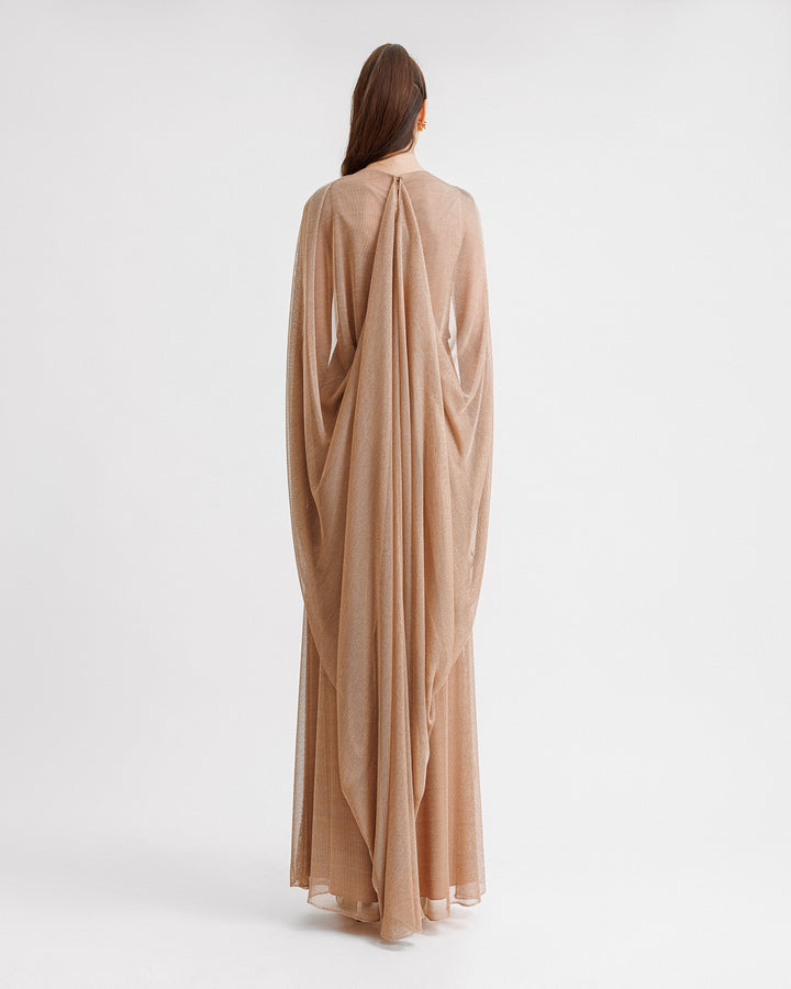 The back of a net tulle evening dress in bronze color with cape-like sleeves, waist and back.