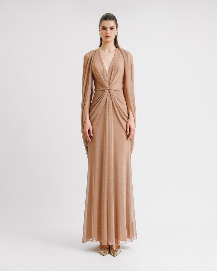 A V-neckline net tulle evening dress in bronze color with draped sleeves and waist.