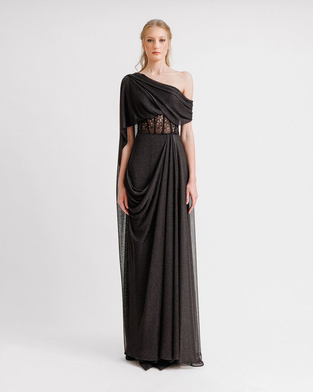 An asymmetrical neckline draped black dress with a structured see-through corset.