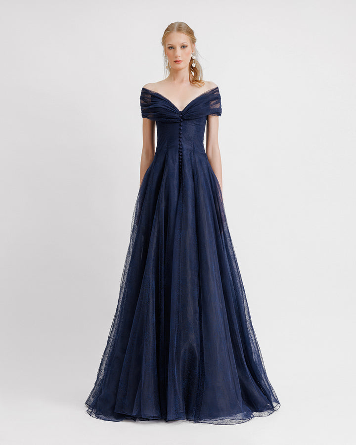 A draped off-the-shoulders navy dress with a buttoned-down front, and a gathered bow closure at the back.