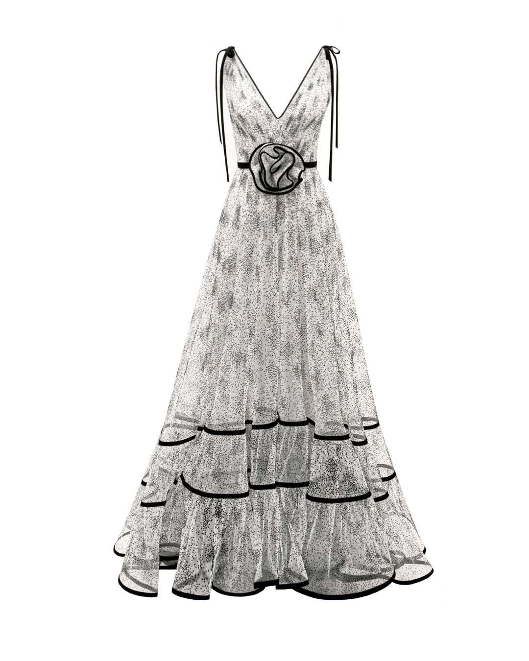 A V-neckline black dotted white tulle evening dress with a flowy structured skirt and a draped flower at the waist.