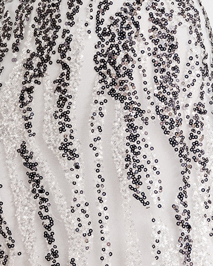 A close-up of a black and white sequins fabric.