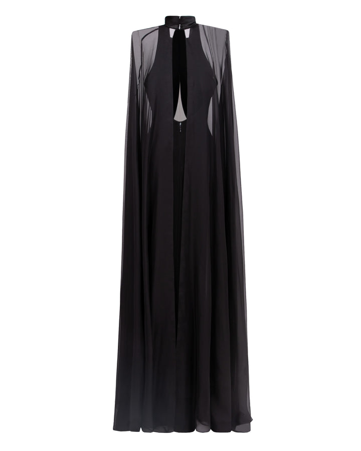 An open back slim cut crepe long black evening dress with see through overlayered cape.