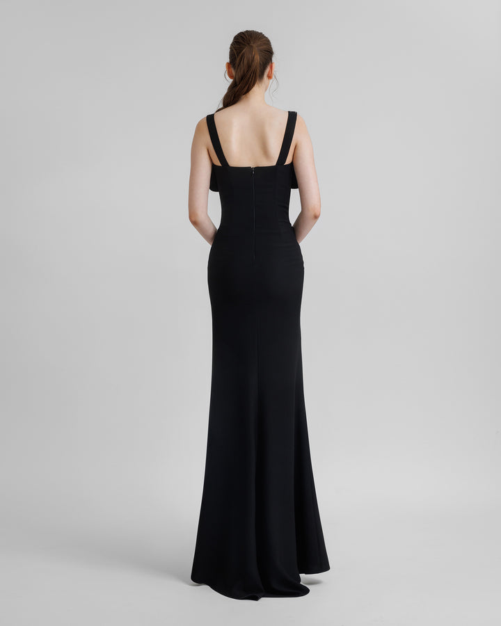 The back of a slim-cut black long evening dress.