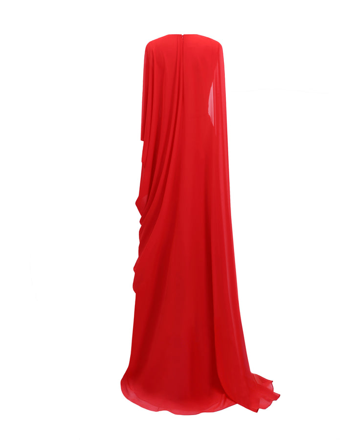 The back of an asymmetrical V-neckline, red evening dress with draping details, and a long cape-like sleeves.