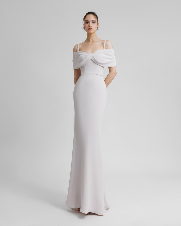 A slim-cut crepe lilac evening dress with an off shoulders bow-like neckline with thin straps, and a belt on the waist.