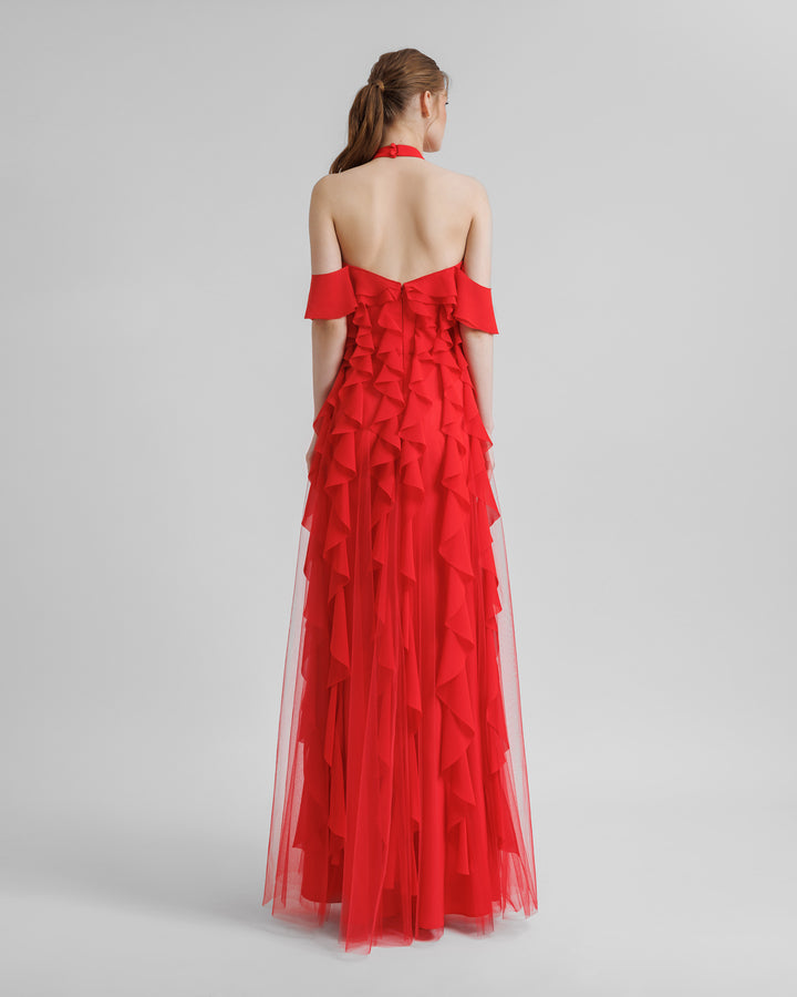 A open back halter-neck red evening dress featuring dropped sleeves and laser-cut embellishments.