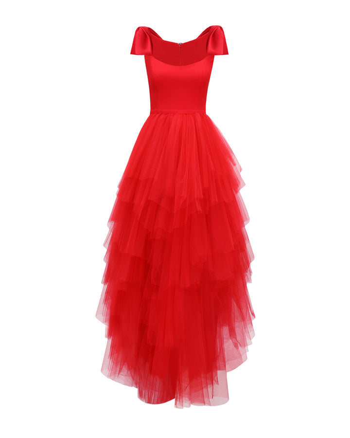 A long red evening dress with bow designs on the shoulders and asymmetrical rushed tulle layered skirt.