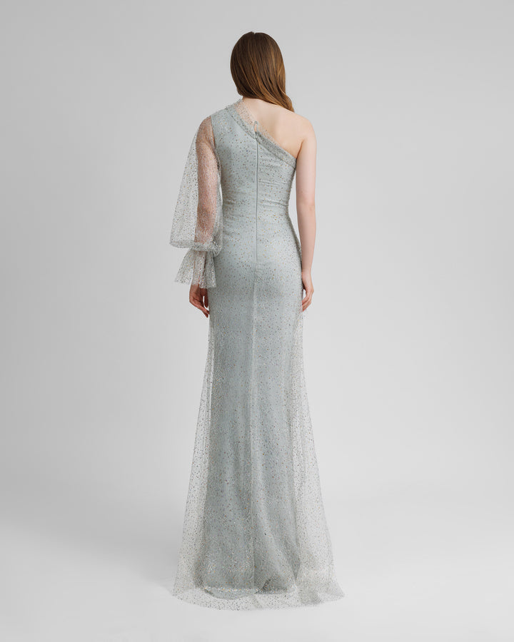 The back of a one shoulder grey evening dress with draping details, and a puffed see-through sleeve.