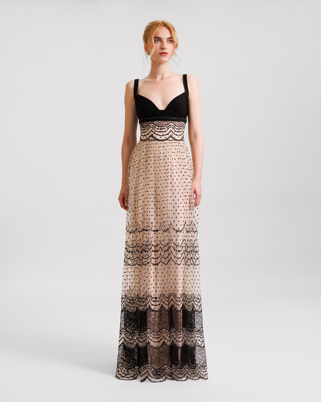 A heart-neckline black and beige evening dress with a defined embroidered waistline.