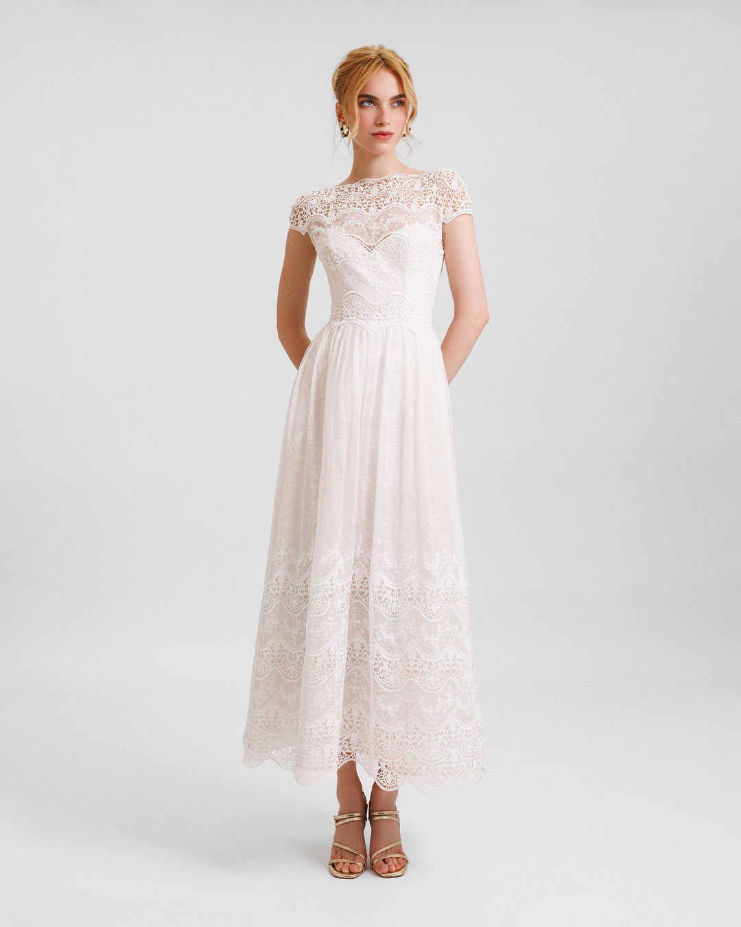 A short-sleeves white midi dress in embroidered lace.