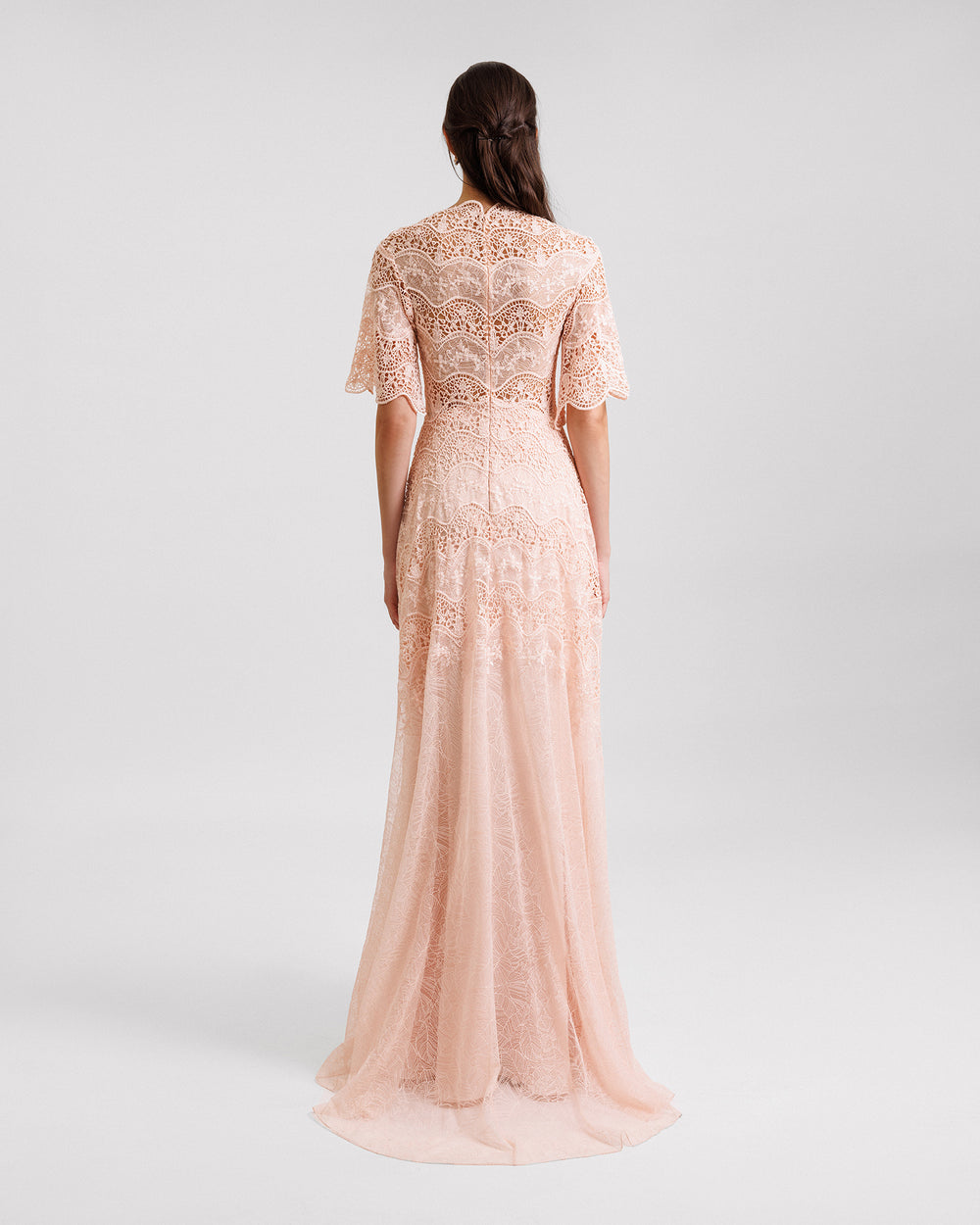 The back of a peach lace evening dress with short bell sleeves.