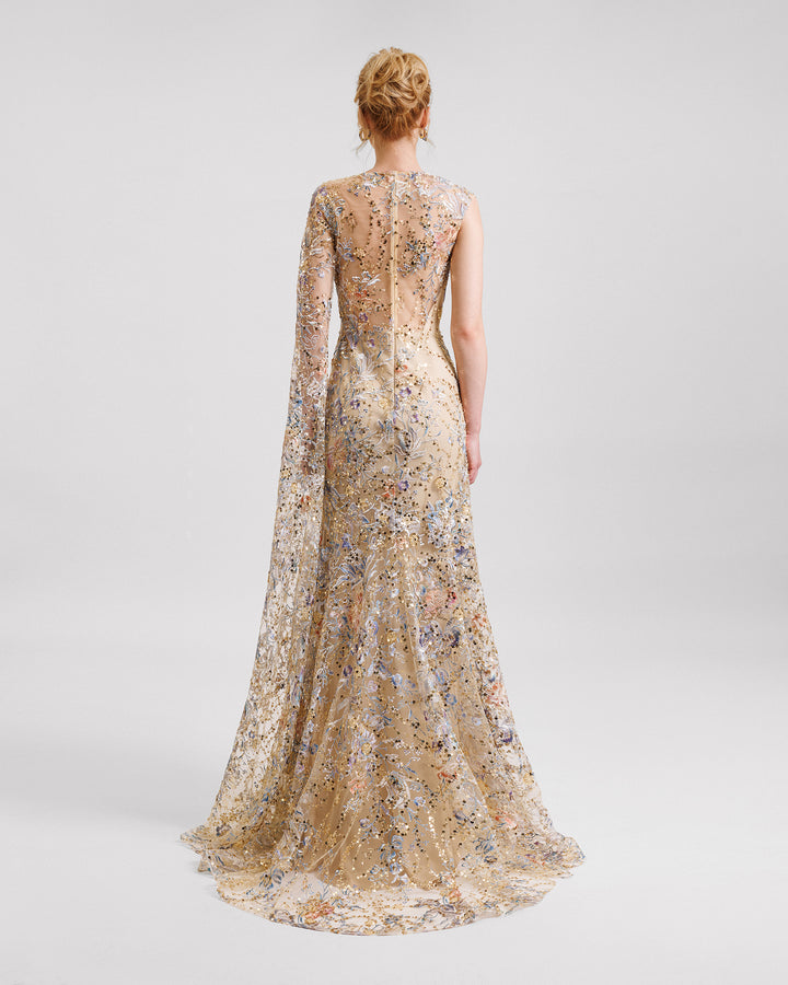 A long evening dress in beaded embroidered fabric with a floor-length sleeve.