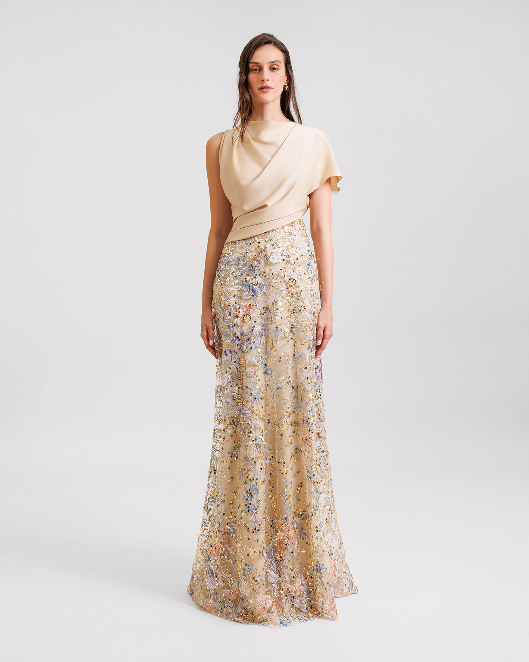 A long evening dress featuring a draped satin corset and a beaded embroidery skirt.