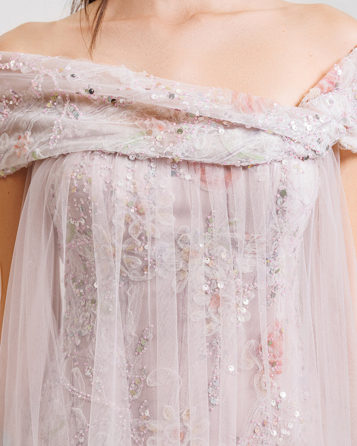 a close-up of an off-the-shoulders beaded embroidery dress in dusty pink with a loose tulle overlay.