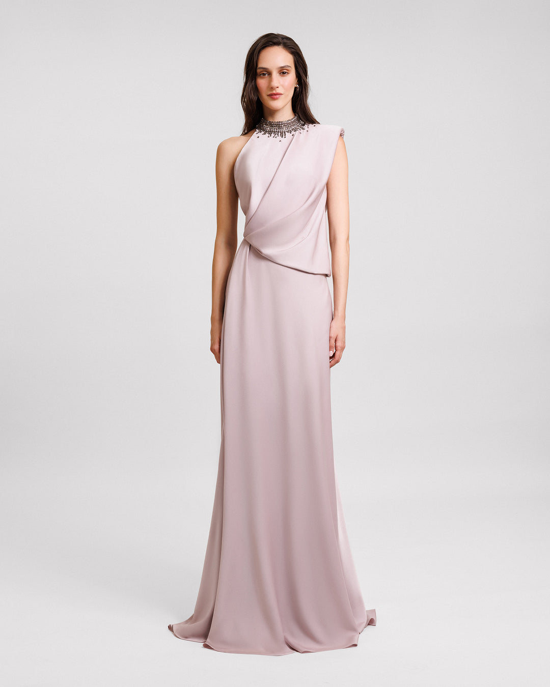 A draped asymmetrical neckline evening dress in dusty pink satin with a stone embellished collar.