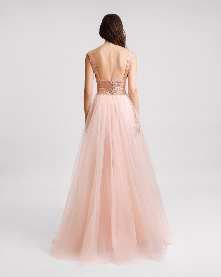 The back of a stone embellished corset evening dress with an open back, and a full tulle skirt.