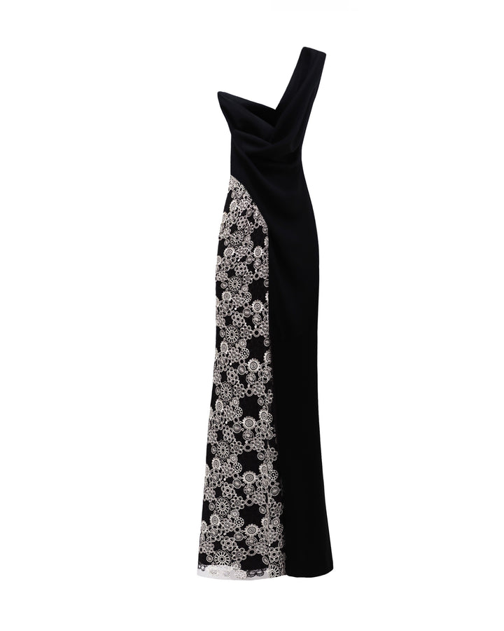 The back of a one-shoulder black evening dress with draping and a slit on one side, and embroidery on the other.