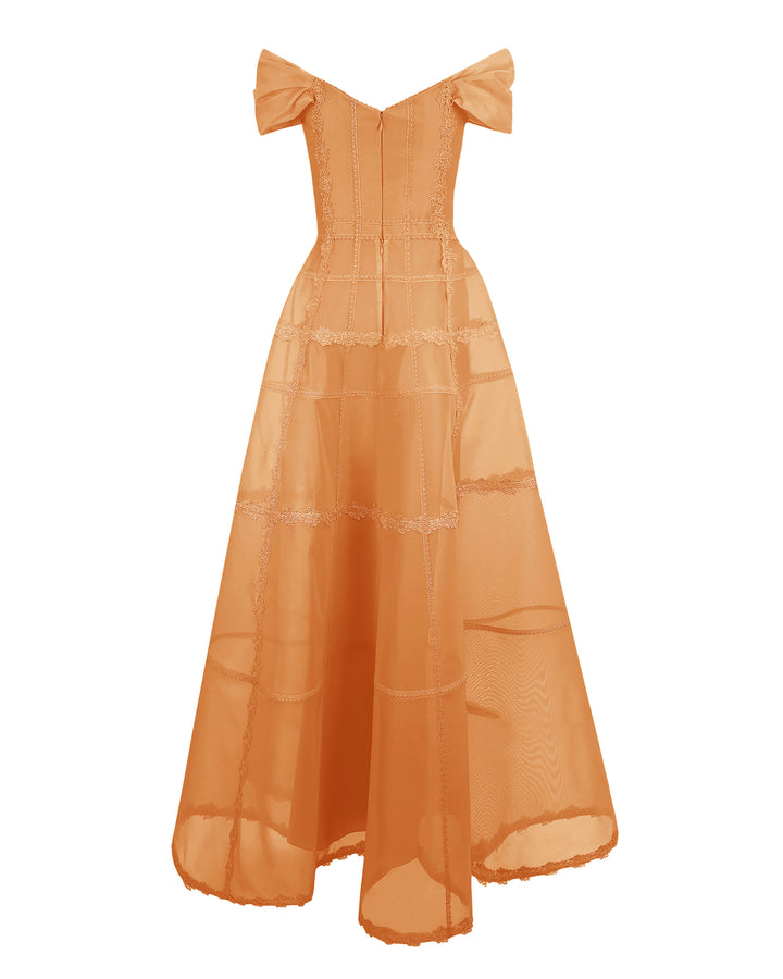 The back of an off-shoulders corset mesh dress in orange with a long wide skirt.