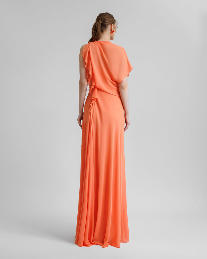 The back of an asymmetrical flared orange dress with draping and ruffled details on the side.