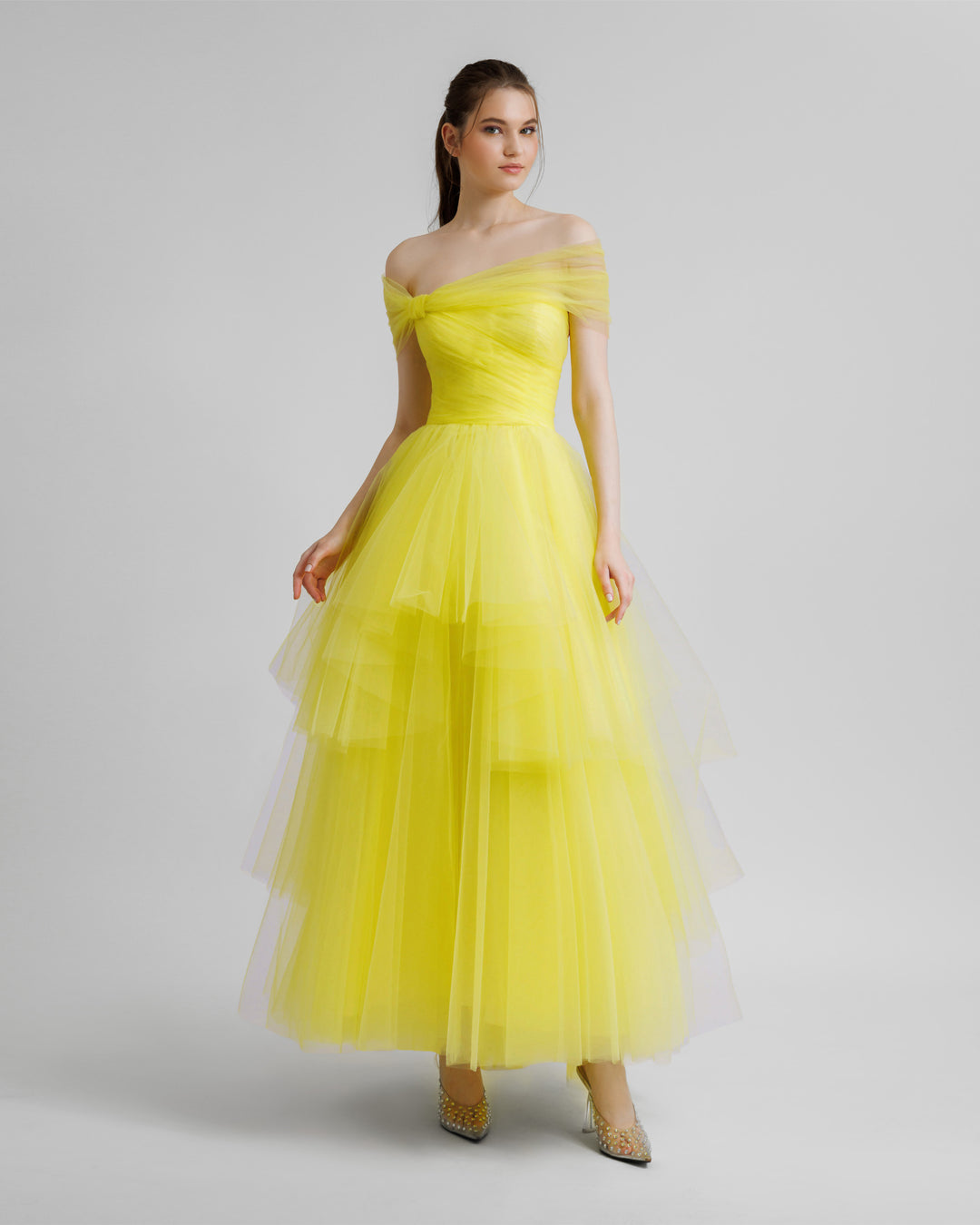 An off-shoulder bow-cut design yellow evening dress with an asymmetrical lower part.