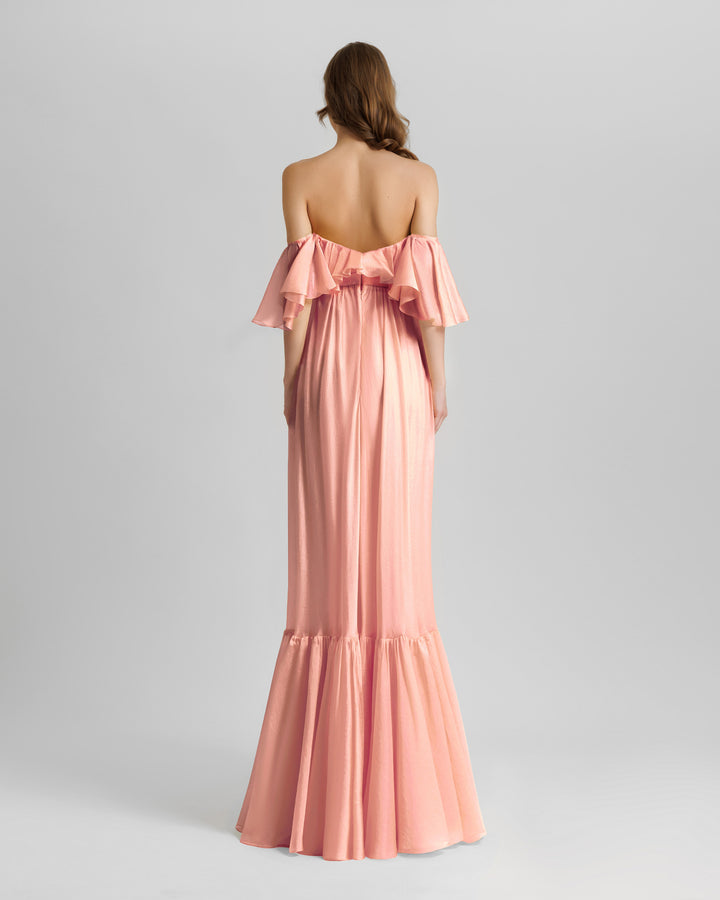 The back of a ruffled off-the-shoulders flowy dress in salmon color.