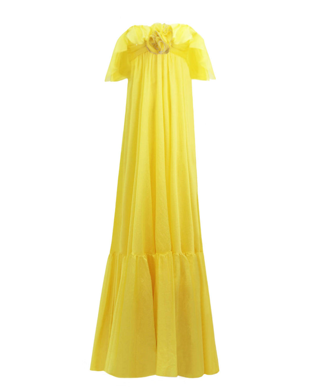 A ruffled off-the-shoulders flowy yellow evening dress with a draped flower at the front.