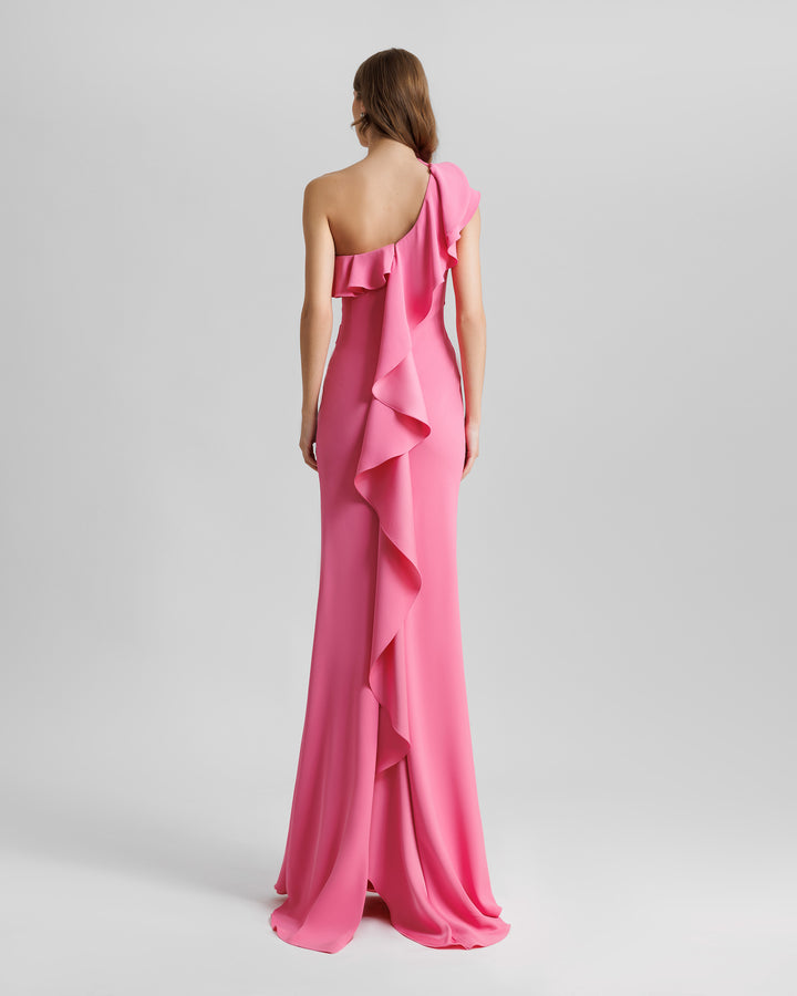 The back of a one-shoulder pink evening dress with a ruffled neckline that goes all the way to the back, to end with a open slit.