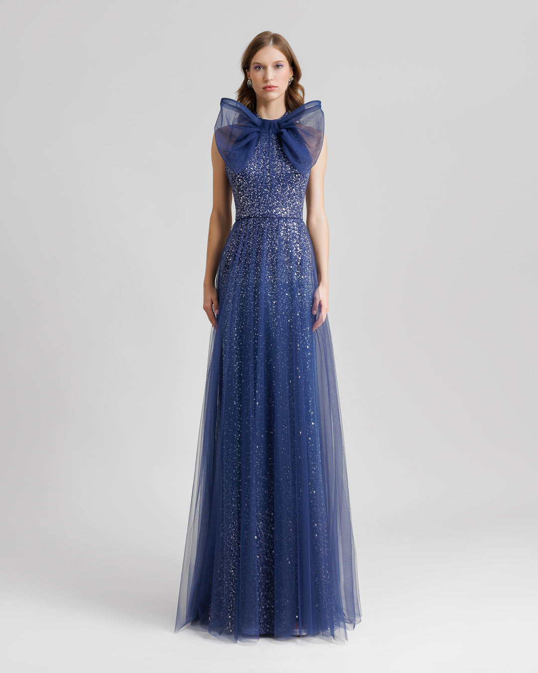 An halter-neck blue dress with a bow design and a beaded underlayer.