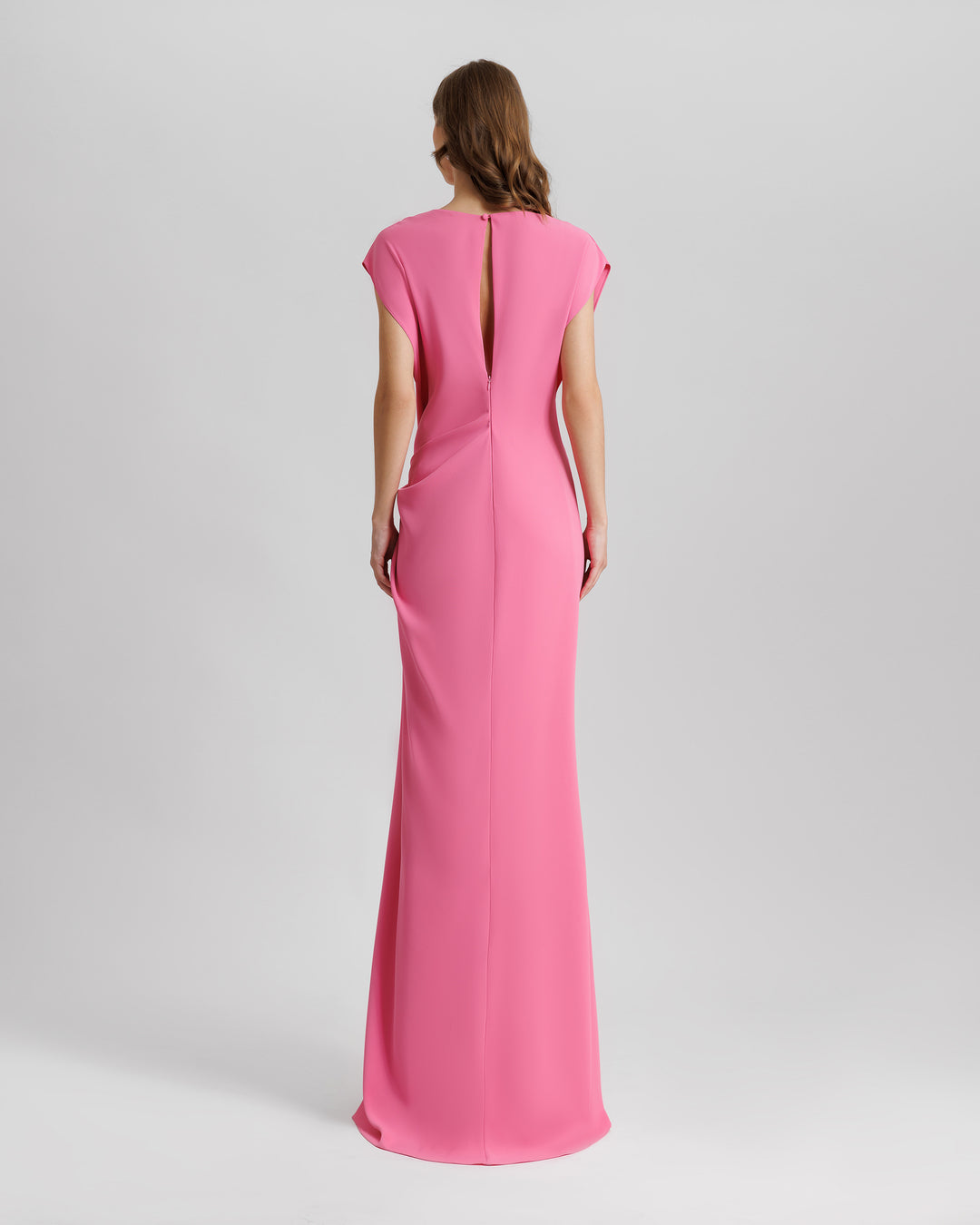 The back of a loose-cut pink evening dress.