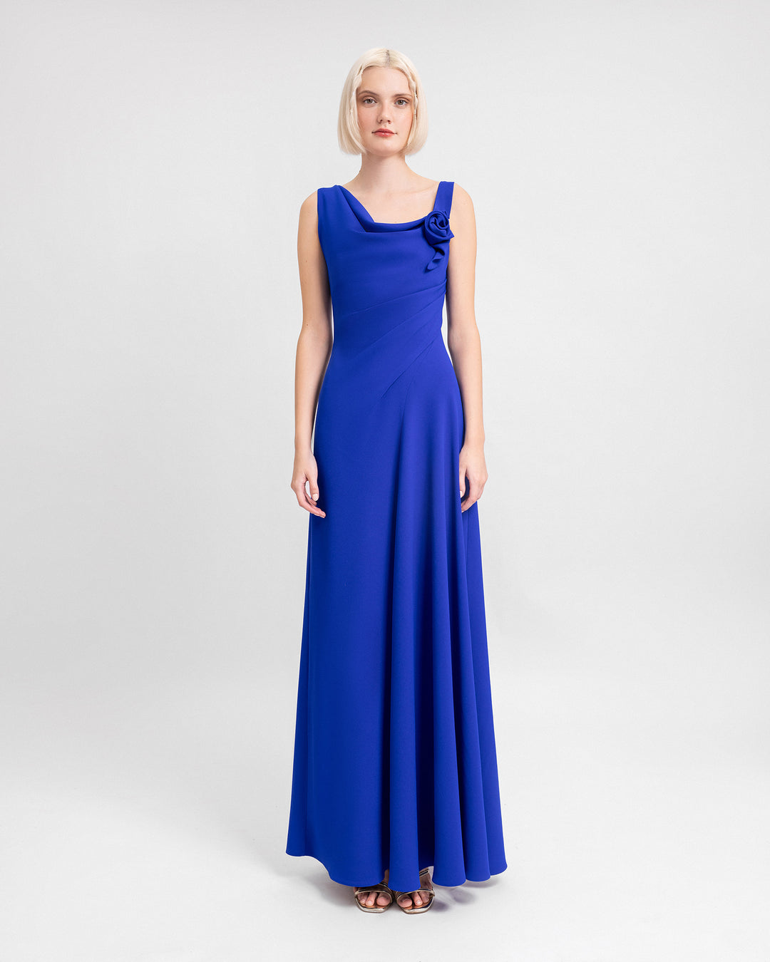 An asymmetrical cowl-neckline blue evening dress with draping on the corset.