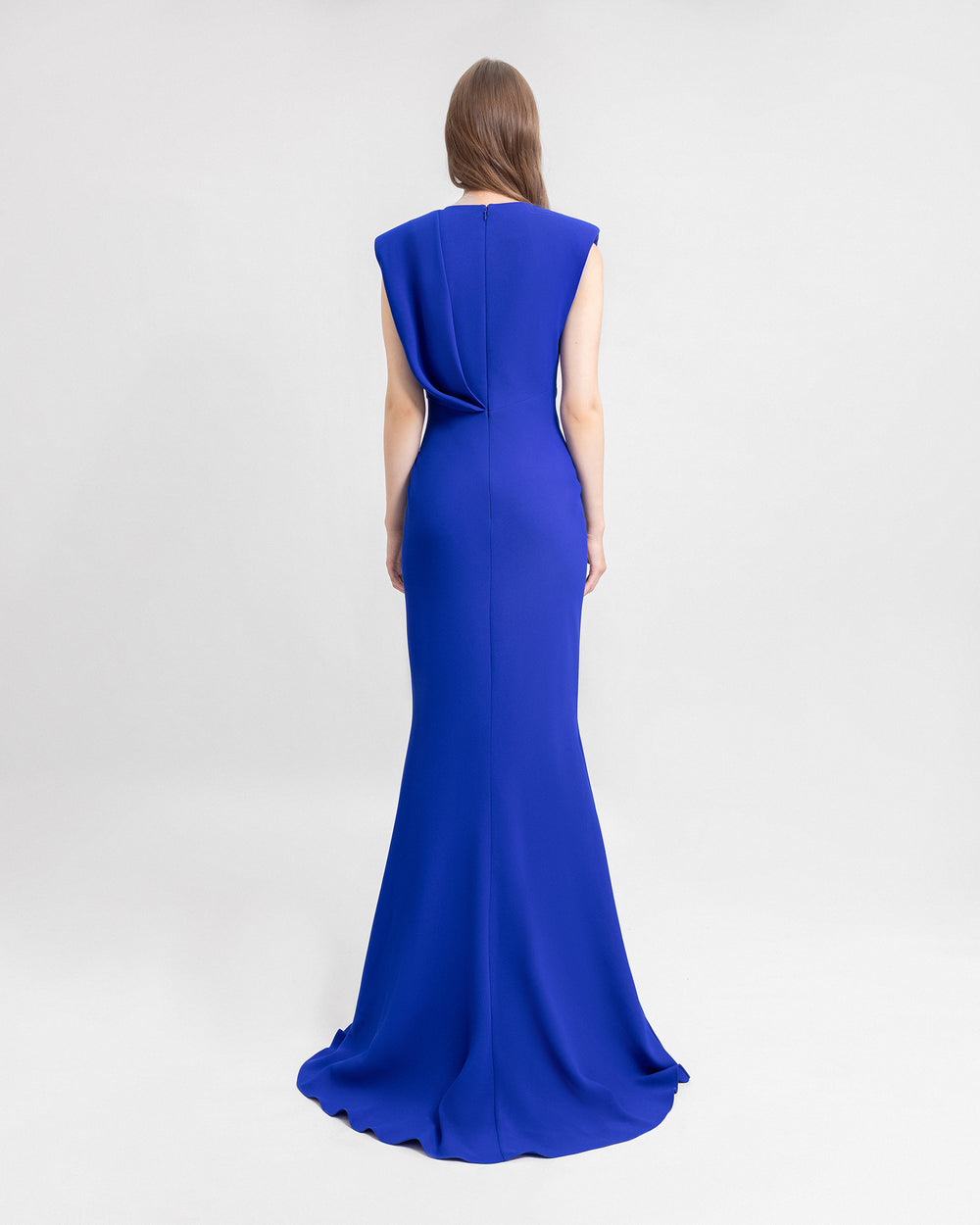 The back of a blue draped evening dress.