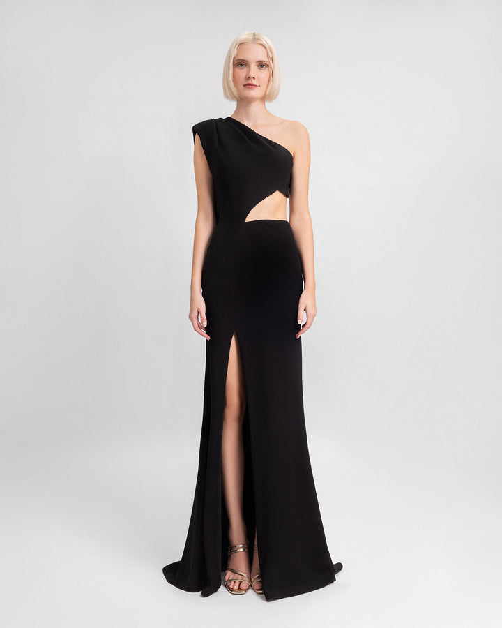 A one-shoulder black evening dress with cut-outs at the side, and a slit at the side.