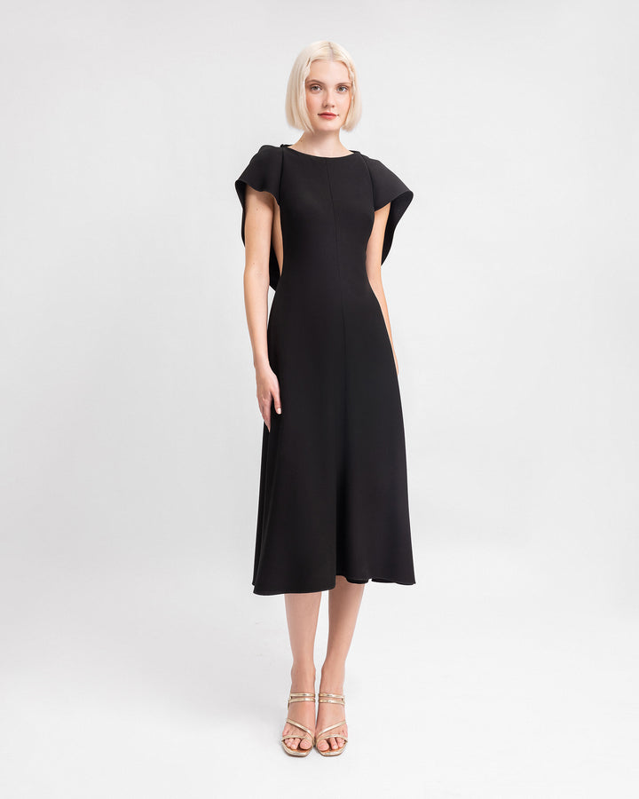 A midi black evening dress with draped sleeves and a cut-out at the back.