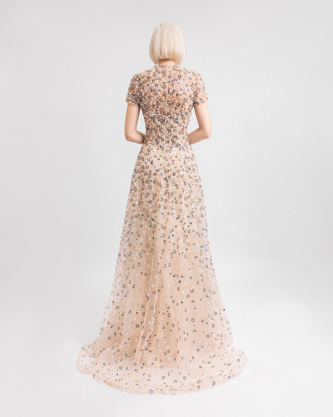 The back of a fully beaded strapless evening dress paired with a removable short-sleeves top.