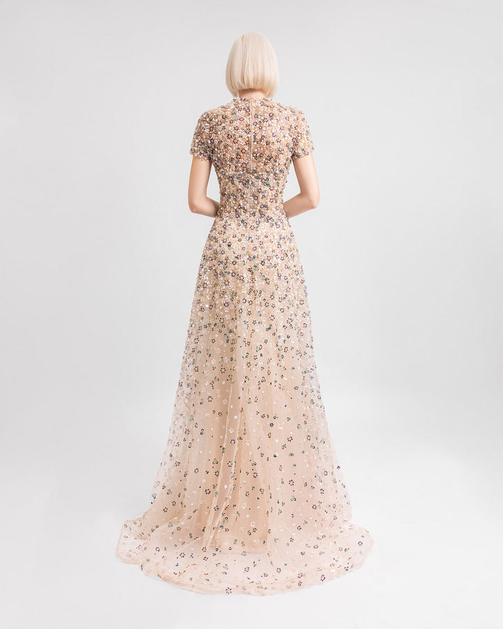 The back of a fully beaded strapless evening dress paired with a removable short-sleeves top.