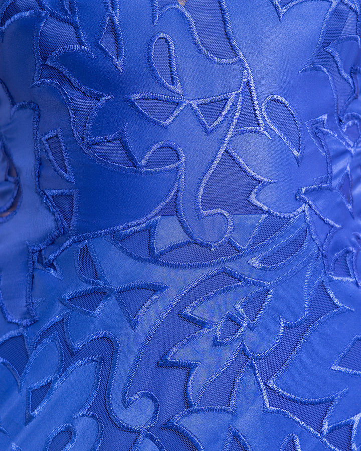 A close-up of a blue embroidered satin dress.