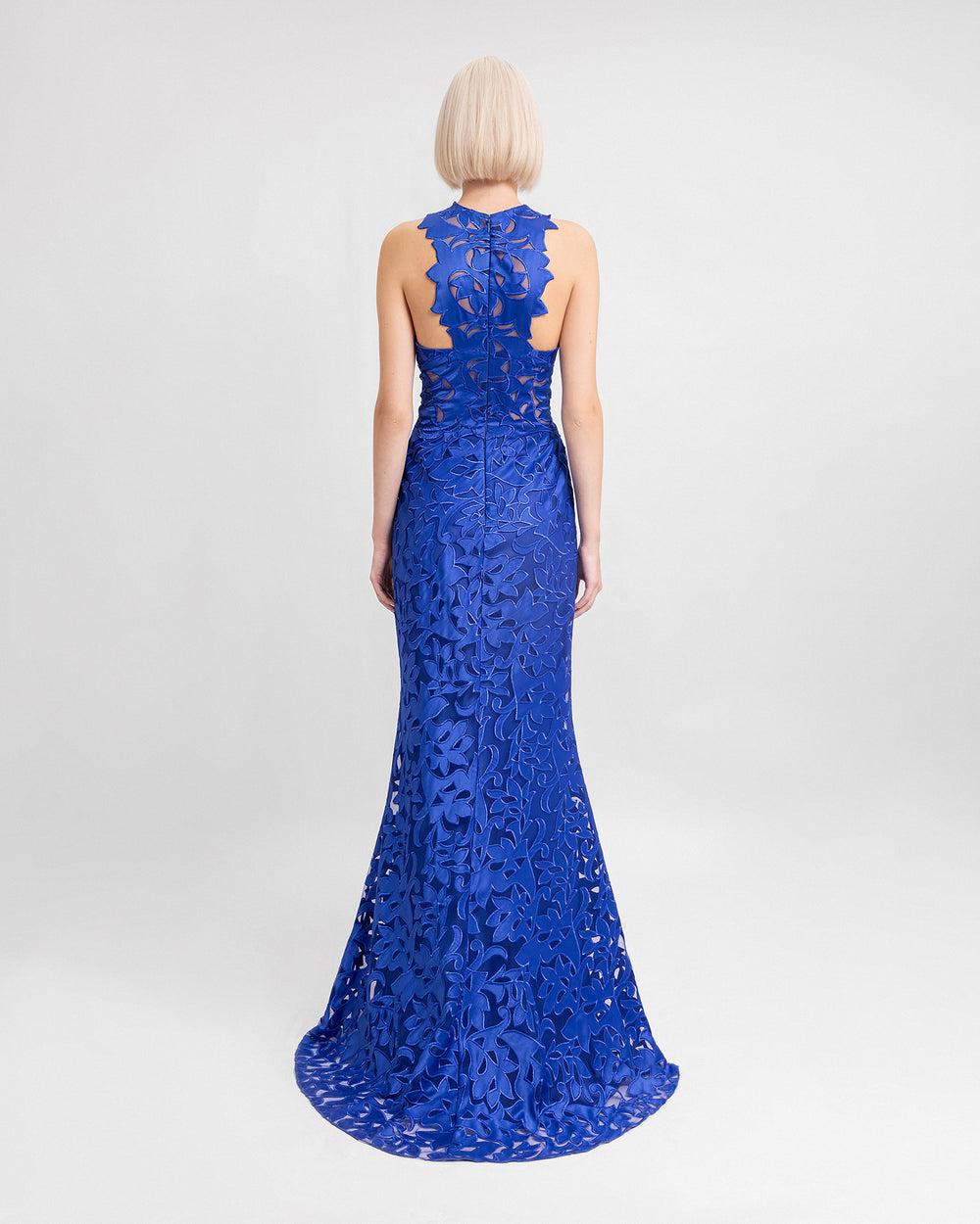 The back of a halter-neckline embroidered satin blue evening dress.