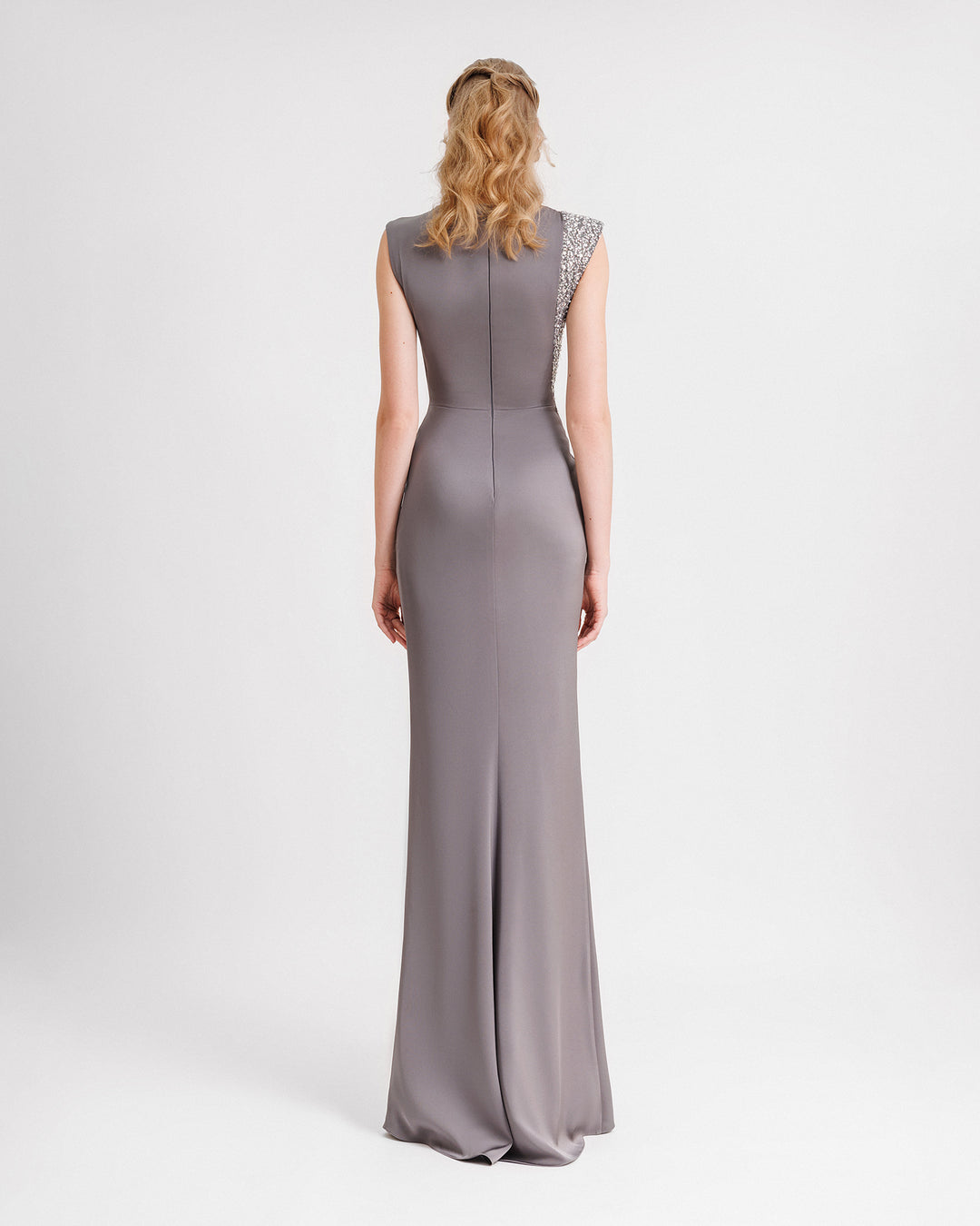 The back of a slim-cut evening dress in smokey grey with a beaded stripe on one side.