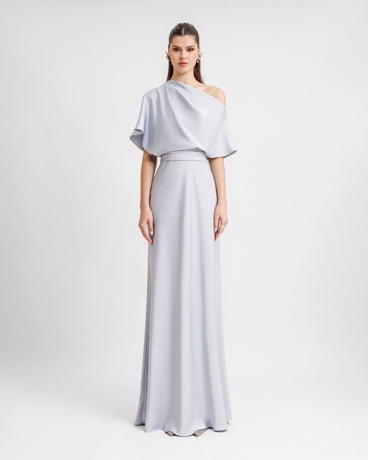 An asymmetrical draped neckline evening dress in light blue satin fabric with an A-cut skirt.