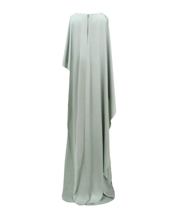 The back of a draped evening dress in teal satin with an asymmetrical cape-like sleeves and back.