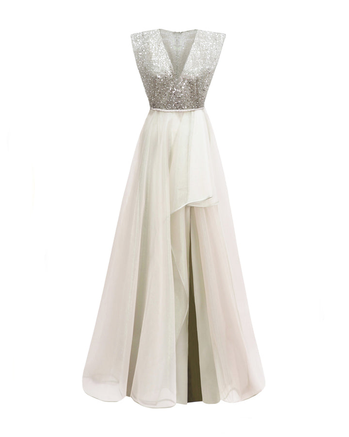 A V-neckline evening dress in light mint green with wide shoulders, a beaded belt on the waist, and an asymmetrical hemline skirt.