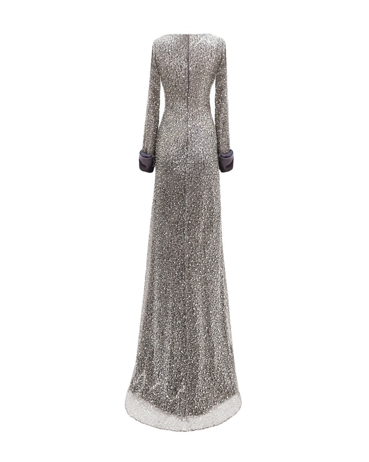 The back of a slim-cut smokey grey evening dress with satin bows on the wrists.