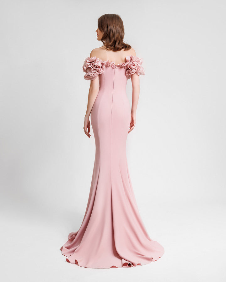 The Bach of a slim-cut pink evening dress featuring off-the-shoulders floral draping.