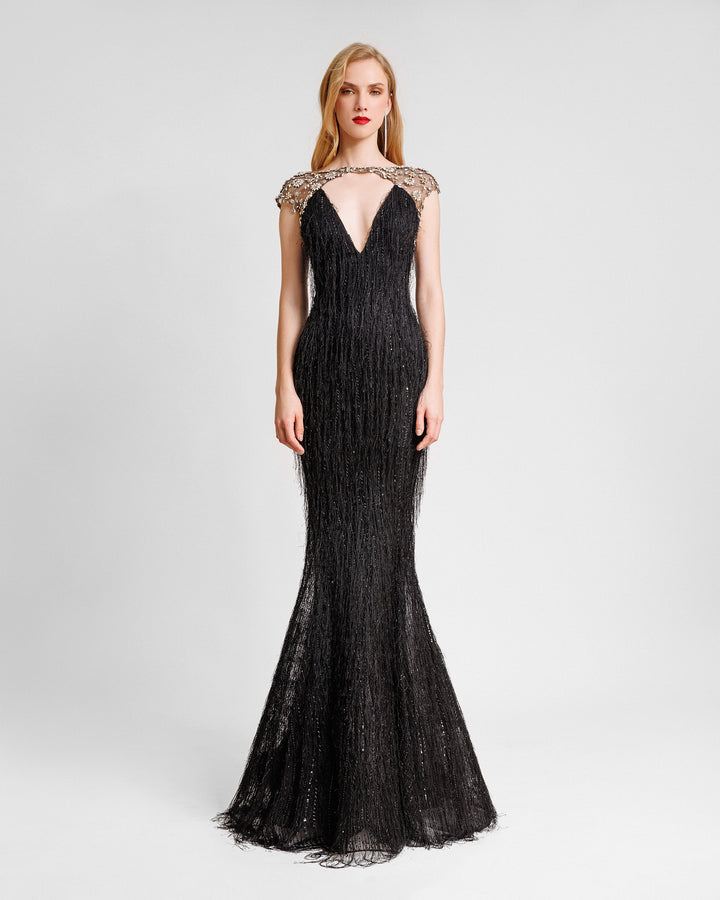 A deep V-neckline black fringes evening dress with a beaded neck and shoulders.